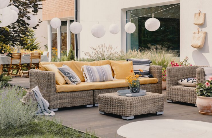Modern back garden with rattan furniture.